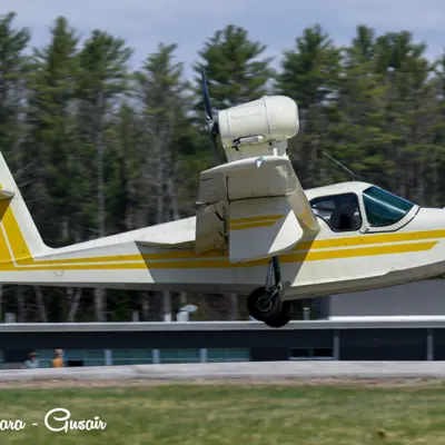 Image shows a small plane taking off. 