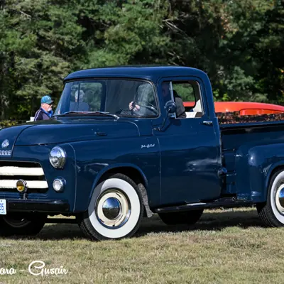 Image shows an antique pick-up truck. 