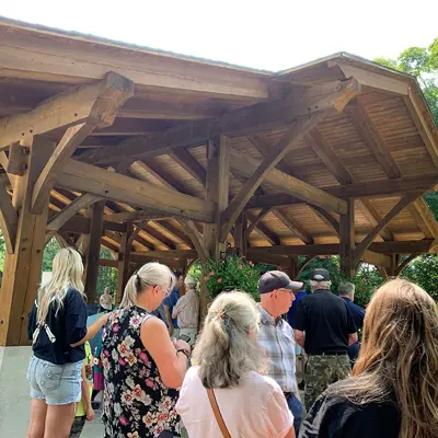 Image shows a crowd of people outside a pavilion. 