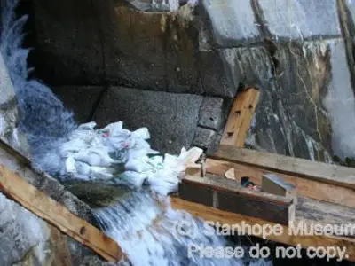 Image shows the new log chute being attached to the dam. 