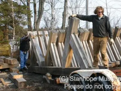 Image shows men inspecting the frame of the new log chute. 