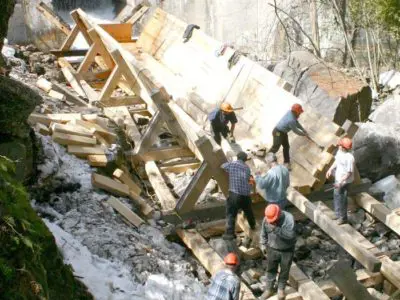 Image shows an overhead shot of the team installing the new log chute. 