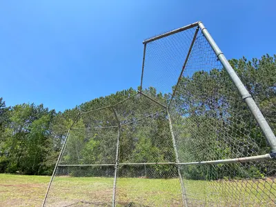 Image shows the backstop of a baseball diamond. 