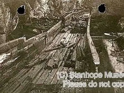 Image shows a black and white photo of construction of the log chute. 