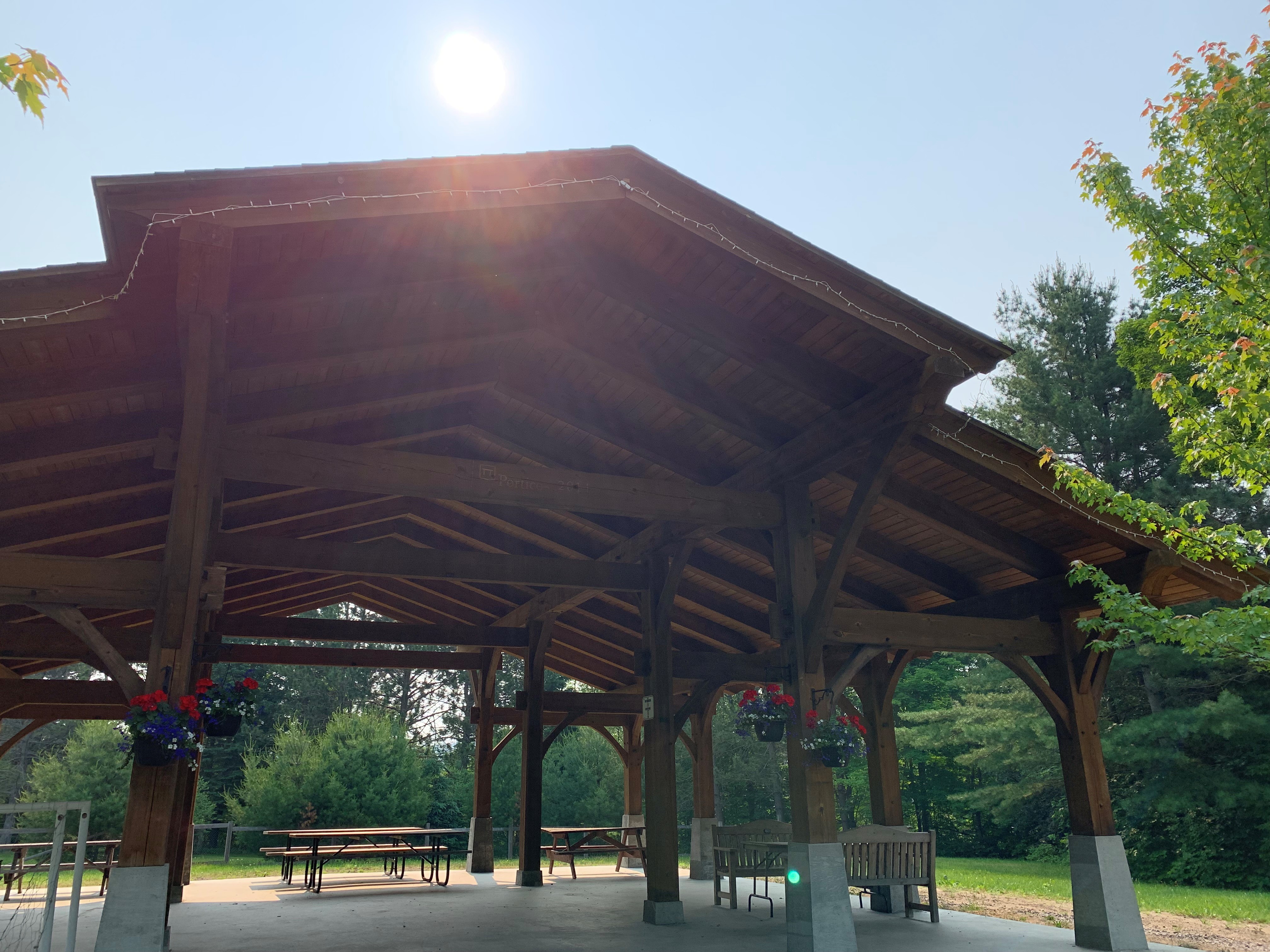 Image shows a picnic pavilion with sun overhead.