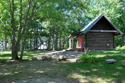 Image shows a wooden building in a park. 