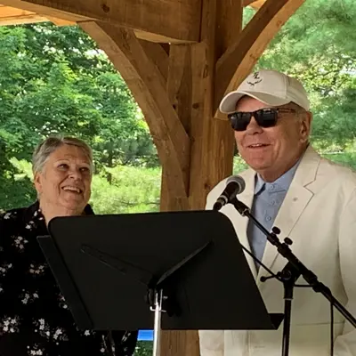 Image shows Mayor Liz Danielsen and Don Tapscott speaking. 