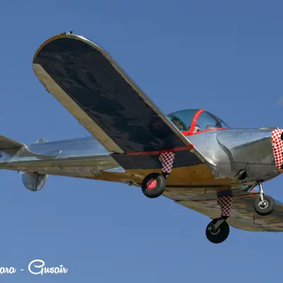 Image shows a small plane in flight. 