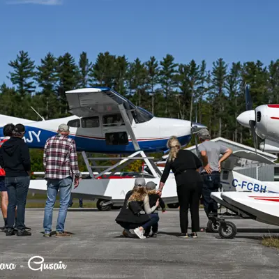 Image shows a family looking at airplanes. 