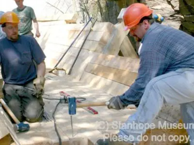 Image shows people working on the installation of the new log chute. 