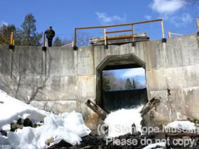 Image shows a concrete dam. 