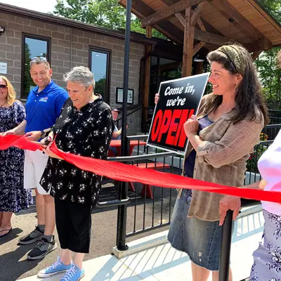 Image shows members of Algonquin Highlands council cutting a ribbon outside the Dorset Recreation Centre. 