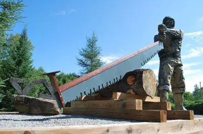 Image shows statue of a lumberjack. 