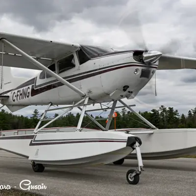 Image shows a pontoon plane on the taxiway. 